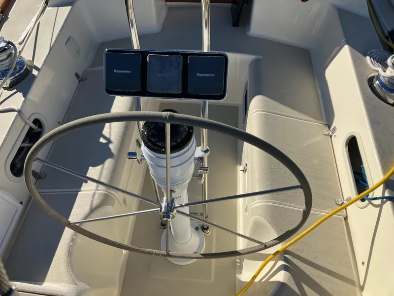 Slide: The Image of Cockpit of 1989 Pearson 39-2 sailboat with steering wheel and Raymarine instruments. - 16