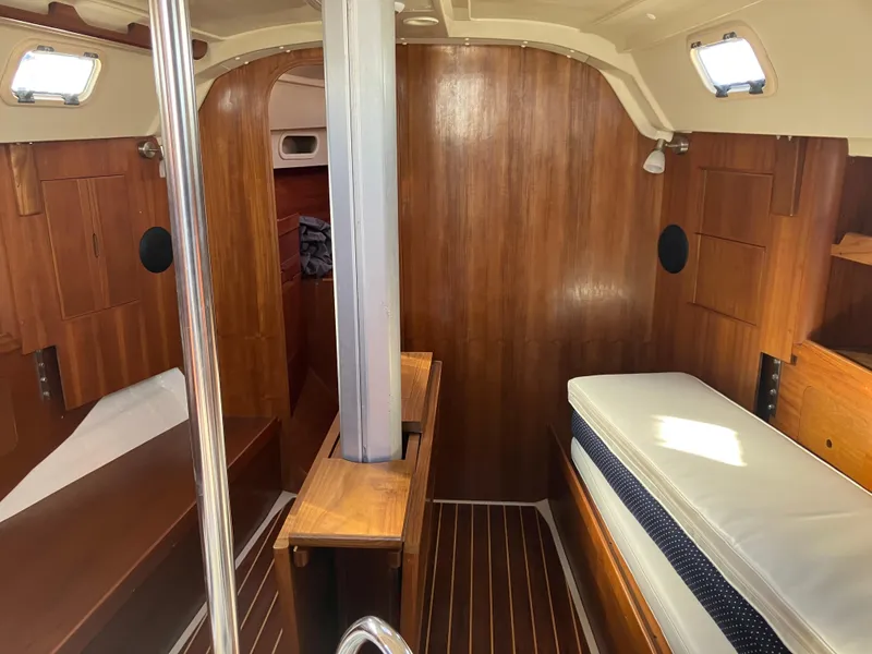 Slide: The Image of Interior of 1989 Pearson 39-2 sailboat with wooden paneling and cushioned seating. - 20