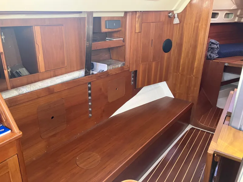 Slide: The Image of 1989 Pearson 39-2 sailboat interior with wooden cabinetry and seating area. - 21