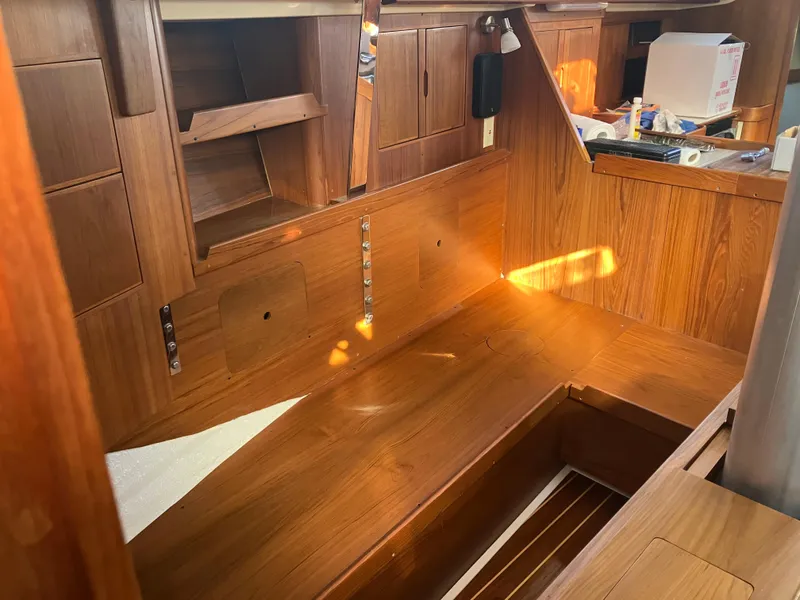 Slide: The Image of Interior of 1989 Pearson 39-2 sailboat with wooden cabinetry and storage compartments. - 22
