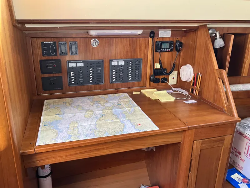 Slide: The Image of Navigation station on 1989 Pearson 39-2 sailboat with map and control panels. - 24