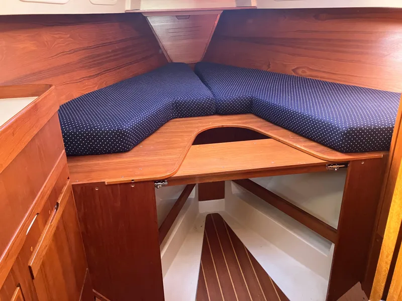 Slide: The Image of Cozy cabin interior of 1989 Pearson 39-2 sailboat with wooden finish and blue cushions. - 29