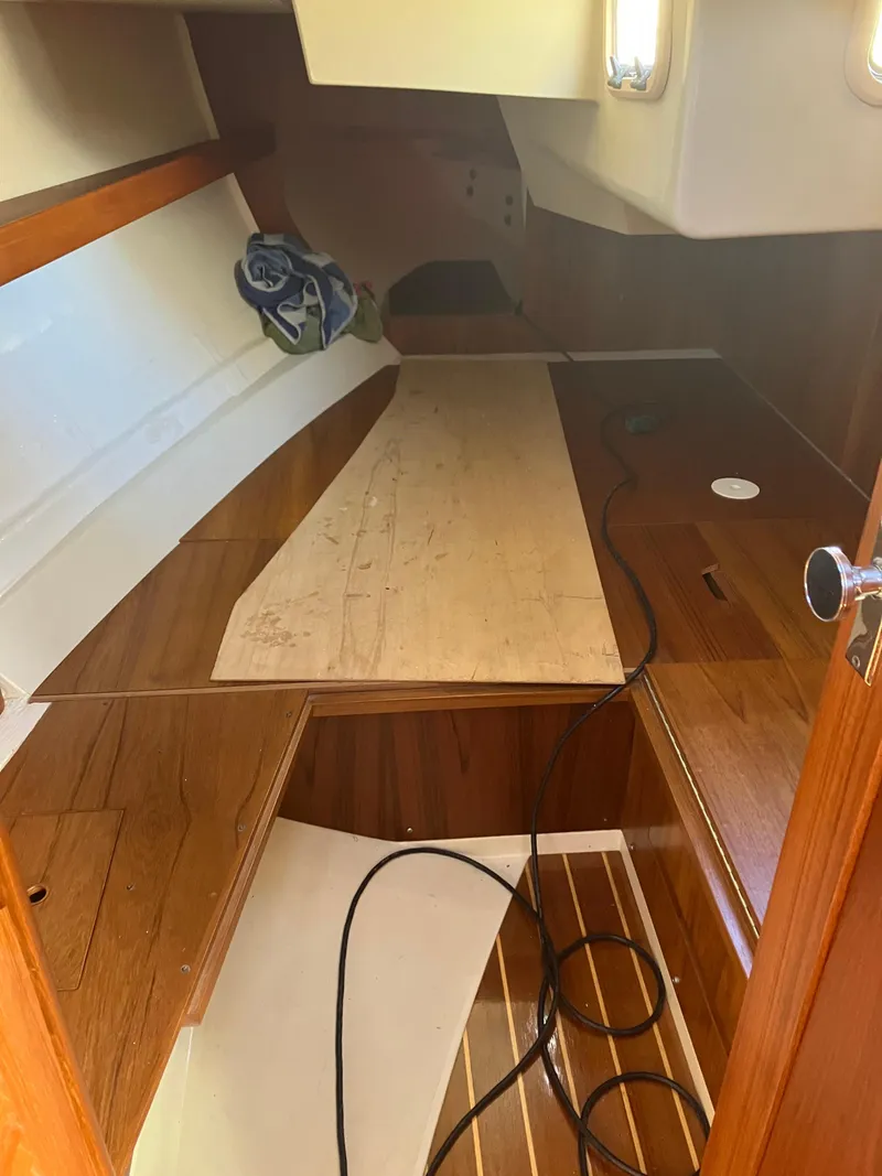 Slide: The Image of Interior of a 1989 Pearson 39-2 sailboat with wooden flooring and storage space. - 30