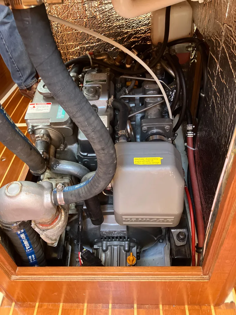 Slide: The Image of Engine compartment of a 1989 Pearson 39-2 sailboat, showing detailed mechanical components. - 34