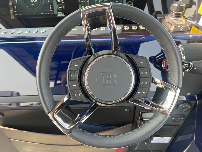 Slide: The Image of Steering wheel of 2023 BRABUS Shadow 900 Deep Blue boat with control buttons. - 12