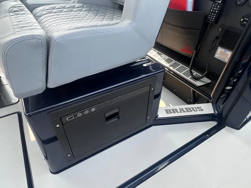 Slide: The Image of BRABUS Shadow 900 Deep Blue 2023 interior with quilted seat and storage compartment. - 16