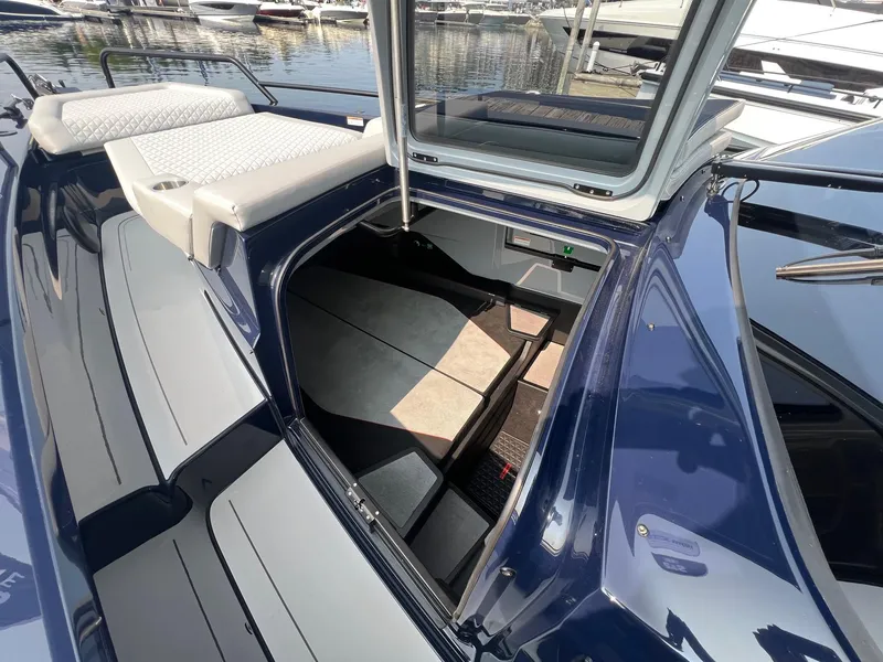 Slide: The Image of BRABUS Shadow 900 Deep Blue 2023 boat interior with open hatch and seating area. - 18