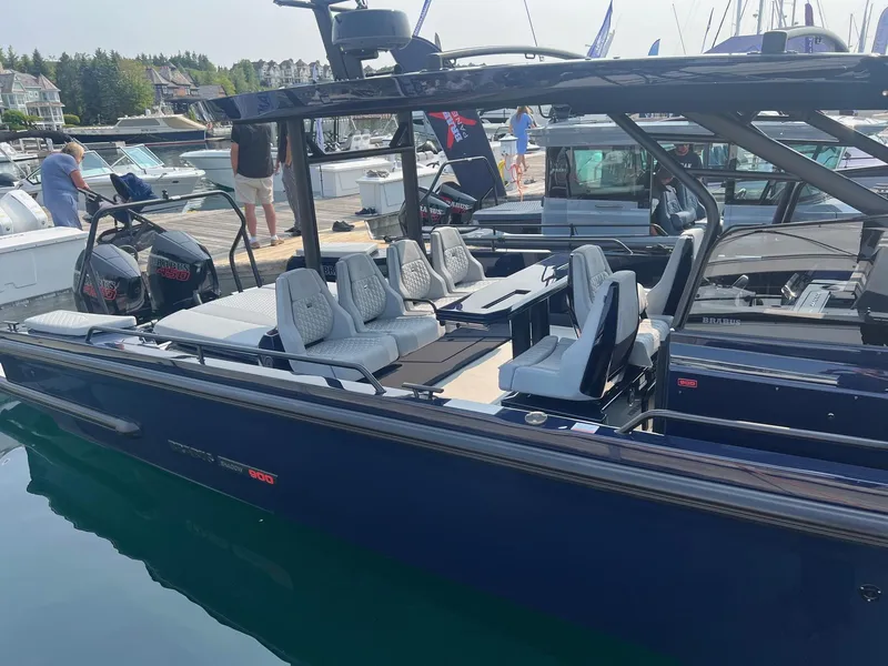 Slide: The Image of 2023 BRABUS Shadow 900 Deep Blue luxury boat docked at marina. - 2