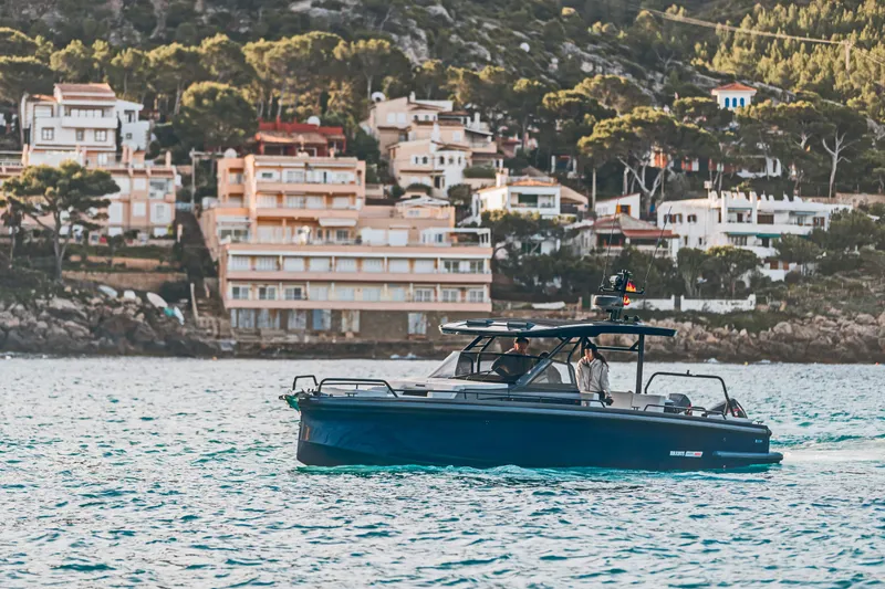 Slide: The Image of 2023 BRABUS Shadow 900 Deep Blue luxury boat cruising near coastal homes. - 28