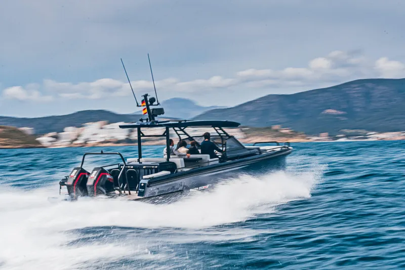 Slide: The Image of 2023 BRABUS Shadow 900 Deep Blue speeding on the water with mountains in the background. - 32