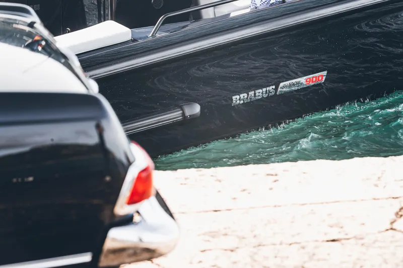 Slide: The Image of 2023 BRABUS Shadow 900 Deep Blue boat docked near a classic car. - 36