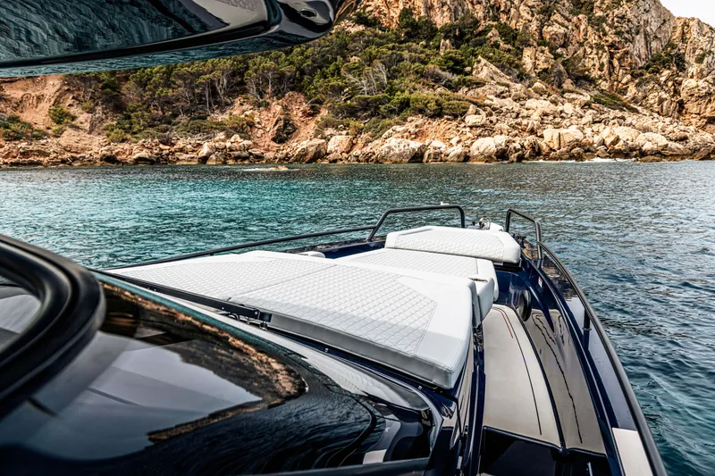 Slide: The Image of 2023 BRABUS Shadow 900 Deep Blue yacht cruising near rocky coastline. - 39