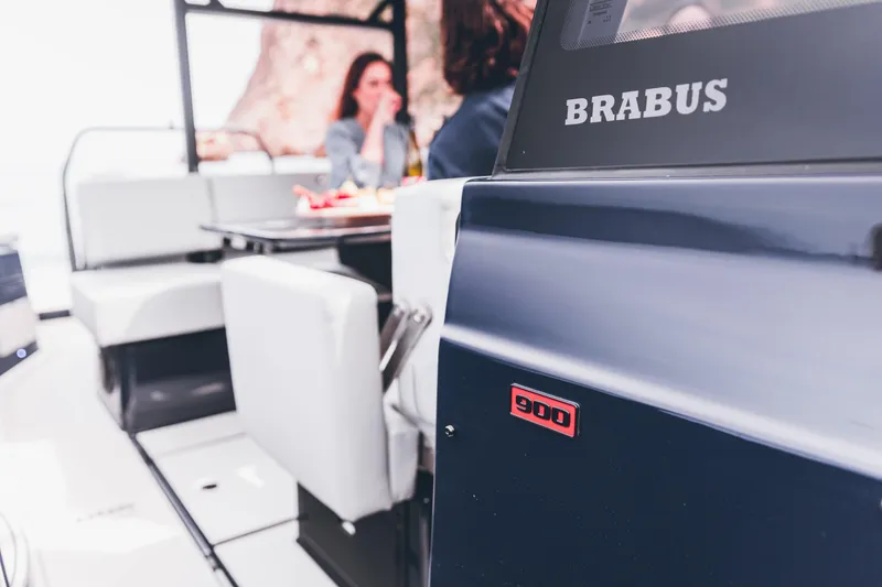 Slide: The Image of 2023 BRABUS Shadow 900 Deep Blue luxury boat interior with people dining. - 42