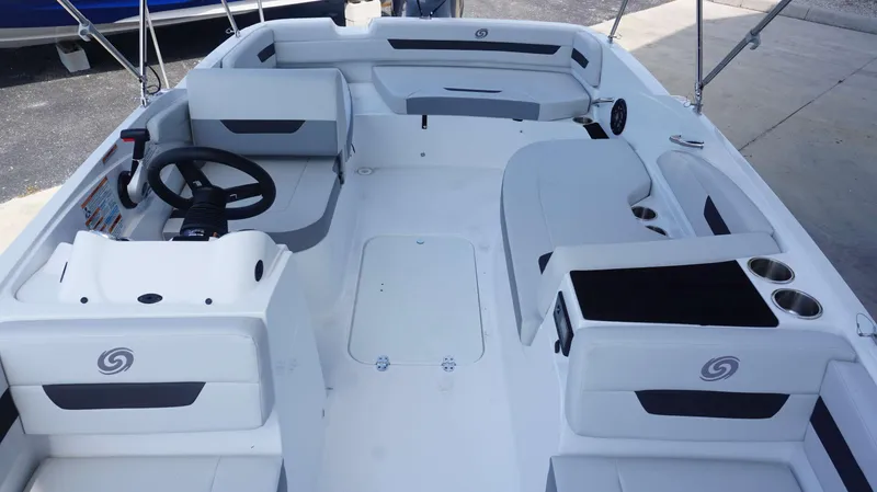 Slide: The Image of 2023 Hurricane 185 SS boat interior with white and gray seating, steering wheel, and cup holders. - 11
