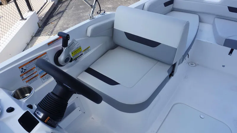 Slide: The Image of 2023 Hurricane 185 SS boat interior with steering wheel and seating. - 13