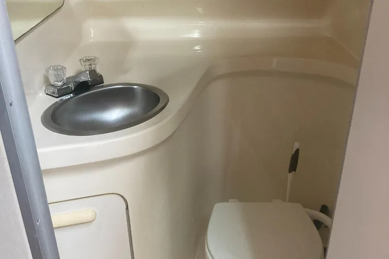 Slide: The Image of 1992 Sea Ray 300 Weekender bathroom with sink and toilet. - 10