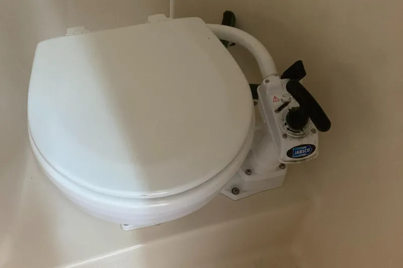Slide: The Image of Marine toilet in 1992 Sea Ray 300 Weekender boat, featuring manual pump handle. - 11