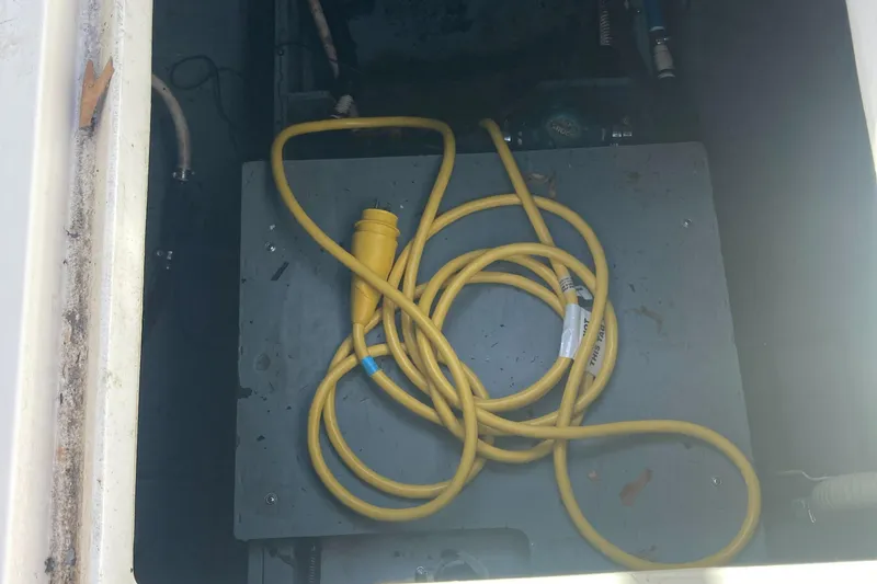 Slide: The Image of Yellow power cable in a 1992 Sea Ray 300 Weekender boat compartment. - 17