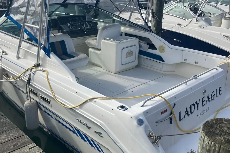 Slide: The Image of 1992 Sea Ray 300 Weekender boat docked, featuring spacious seating and clean design. - 3