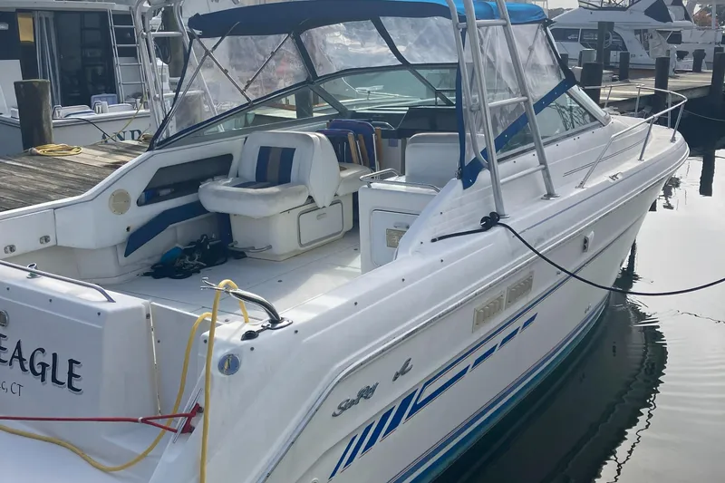 Slide: The Image of 1992 Sea Ray 300 Weekender boat docked at marina with blue accents. - 4