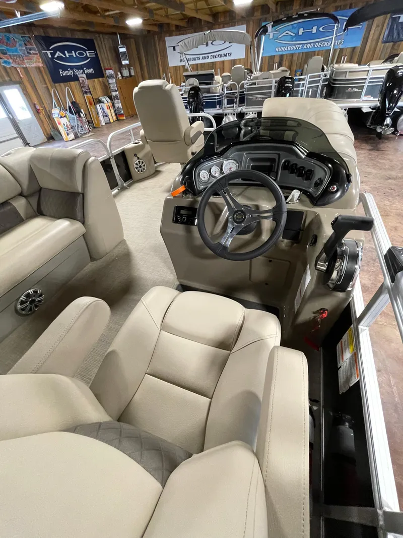 Slide: The Image of 2023 Sun Tracker SportFish 20 DLX interior with beige seating and modern dashboard. - 2