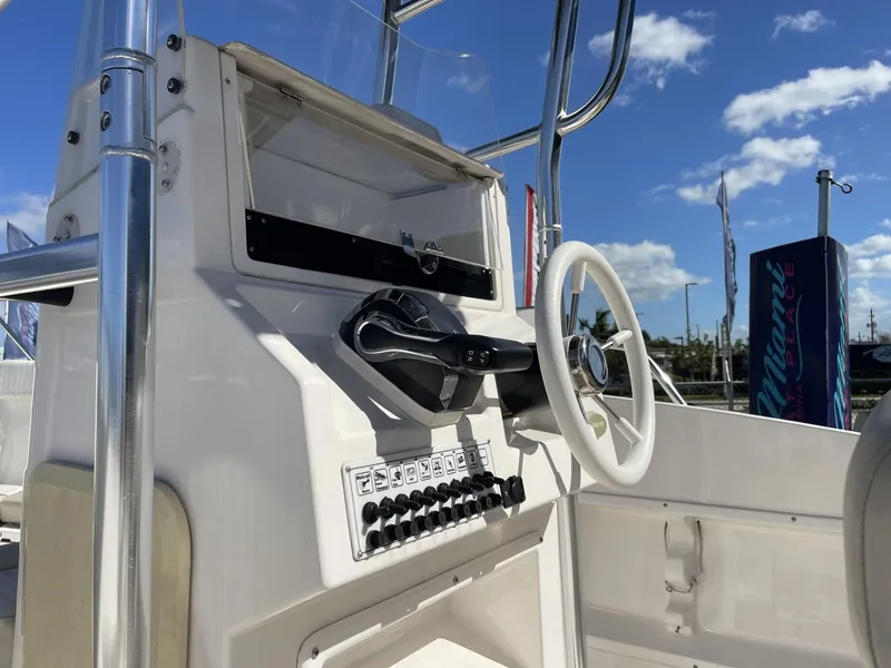 Slide: The Image of 2022 Wellcraft 220CC boat console with steering wheel and control panel. - 12