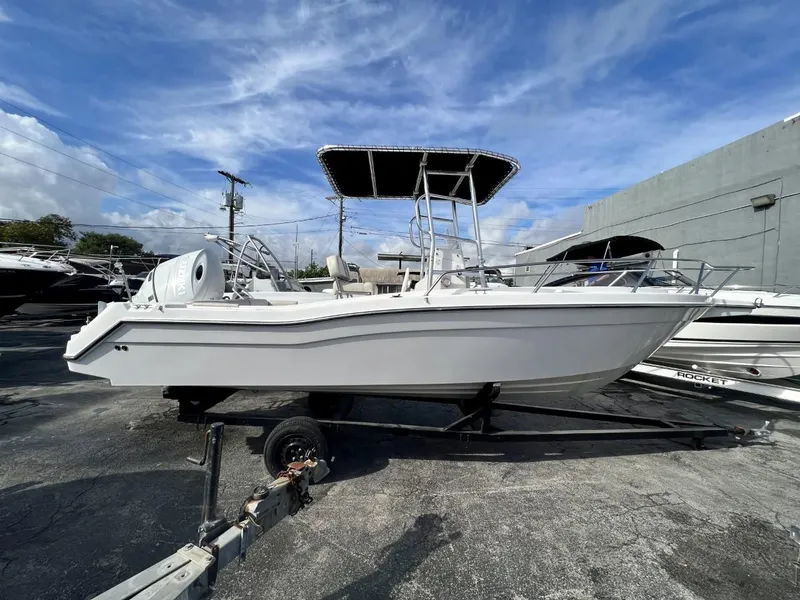 Slide: The Image of 2022 Wellcraft 220CC boat on trailer under blue sky. - 14