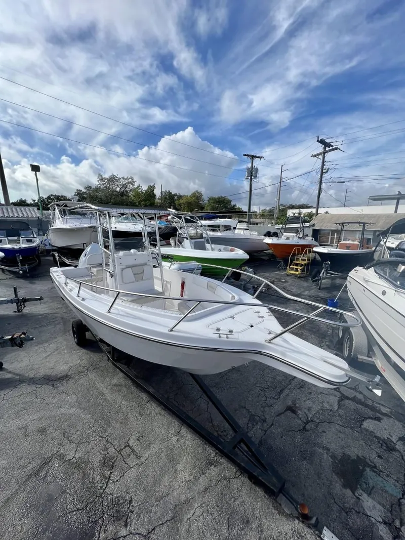 Slide: The Image of 2022 Wellcraft 220CC center console boat on a trailer in a marina. - 19