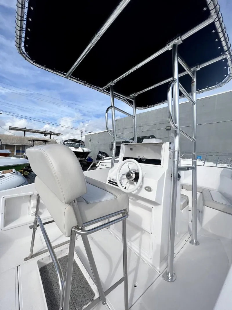 Slide: The Image of 2022 Wellcraft 220CC center console boat with T-top and helm station. - 22