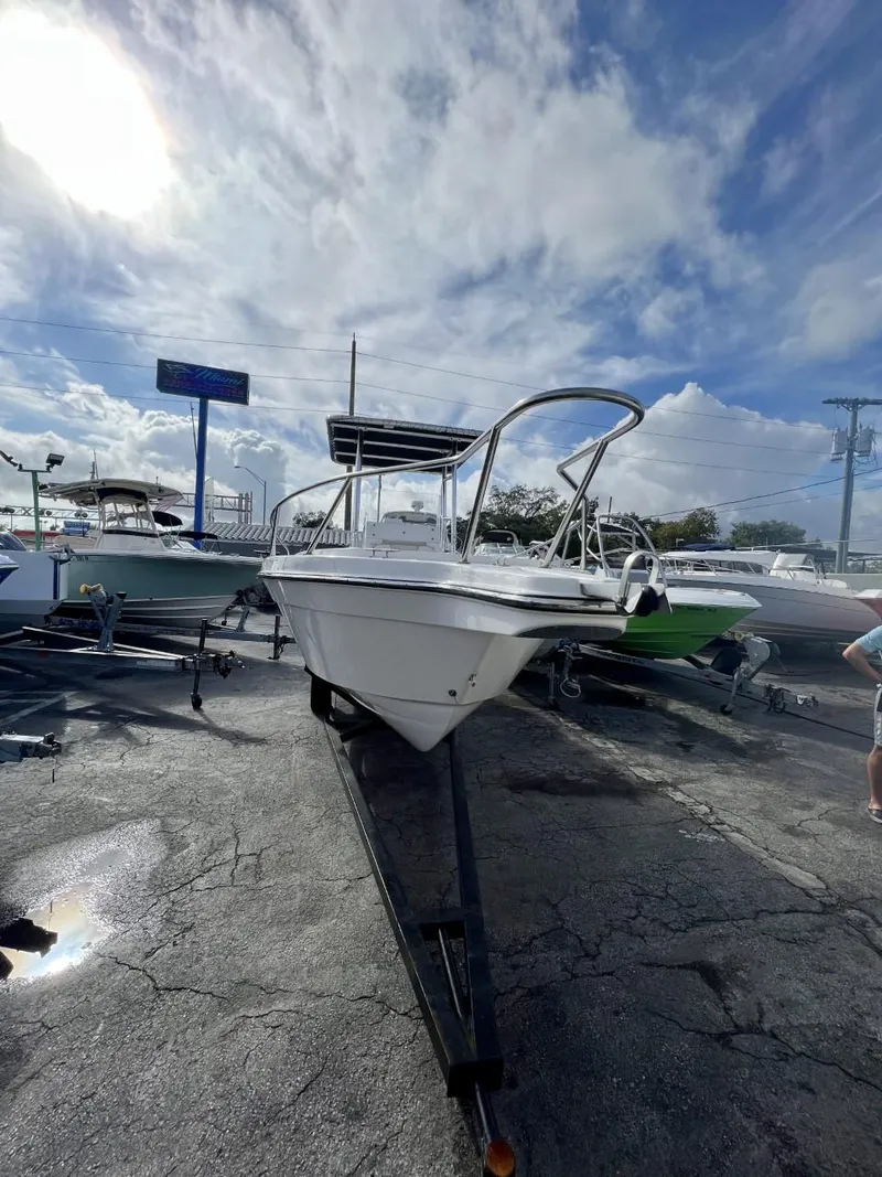 Slide: The Image of 2022 Wellcraft 220CC boat on a trailer under a cloudy sky. - 24