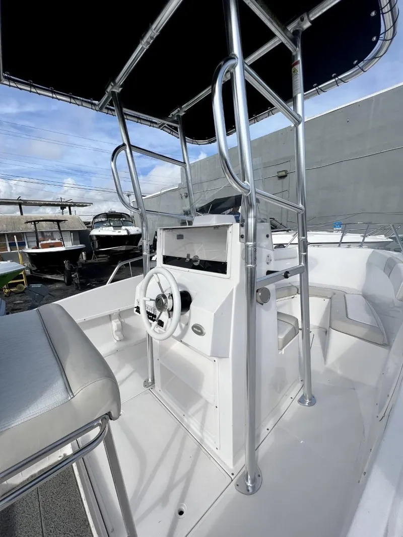 Slide: The Image of 2022 Wellcraft 220CC center console boat with T-top and steering wheel. - 25