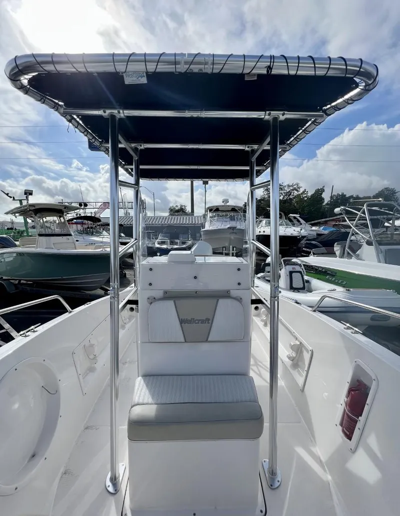 Slide: The Image of 2022 Wellcraft 220CC center console boat with T-top and seating. - 28