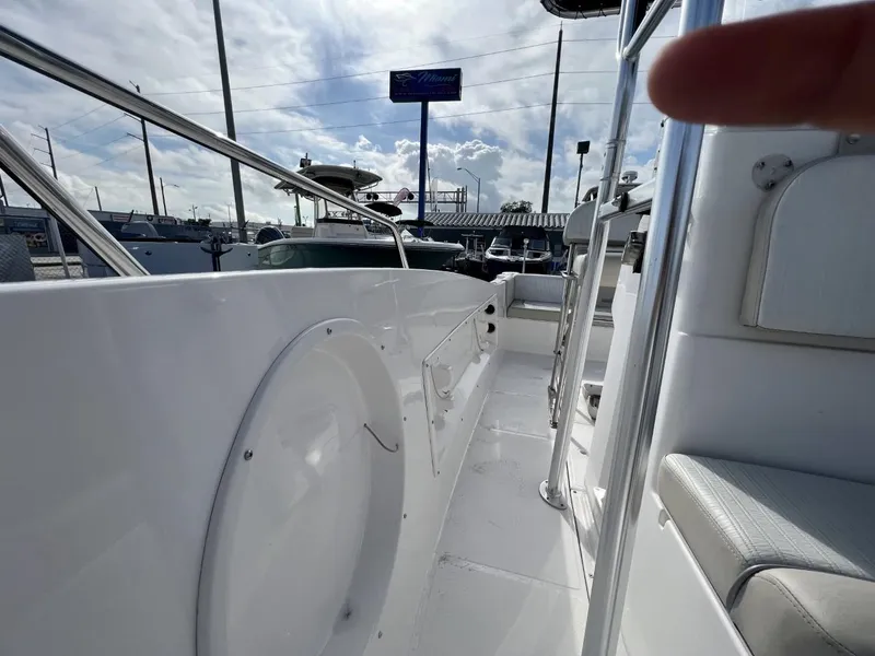 Slide: The Image of 2022 Wellcraft 220CC boat interior with white seating and railings. - 30