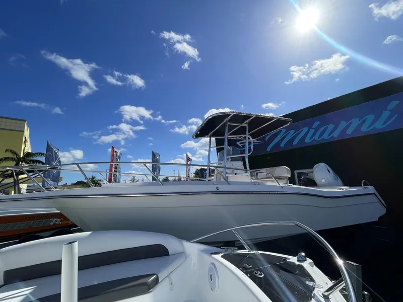 Slide: The Image of 2022 Wellcraft 220CC boat displayed at Miami boat show under a sunny sky. - 9