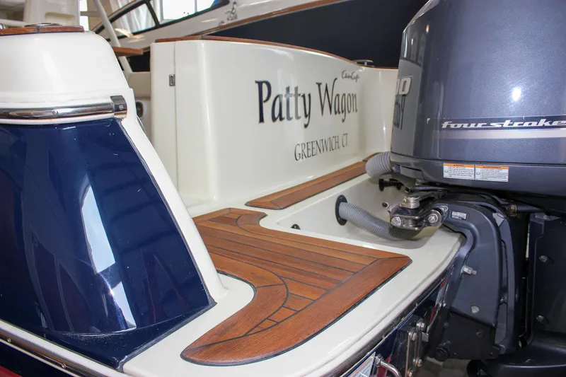 Slide: The Image of 2014 Chris-Craft Catalina 29 Sun Tender with wooden deck and outboard motor. - 11