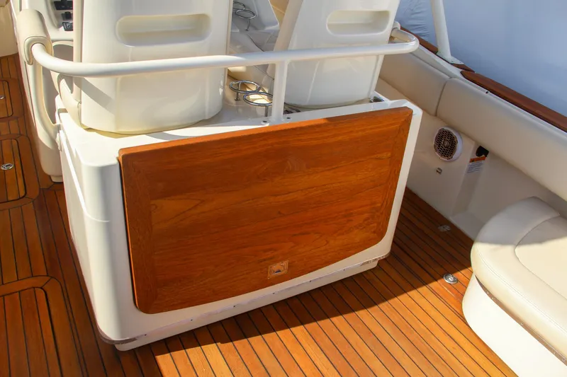 Slide: The Image of 2014 Chris-Craft Catalina 29 Sun Tender interior with wooden paneling and seating. - 15