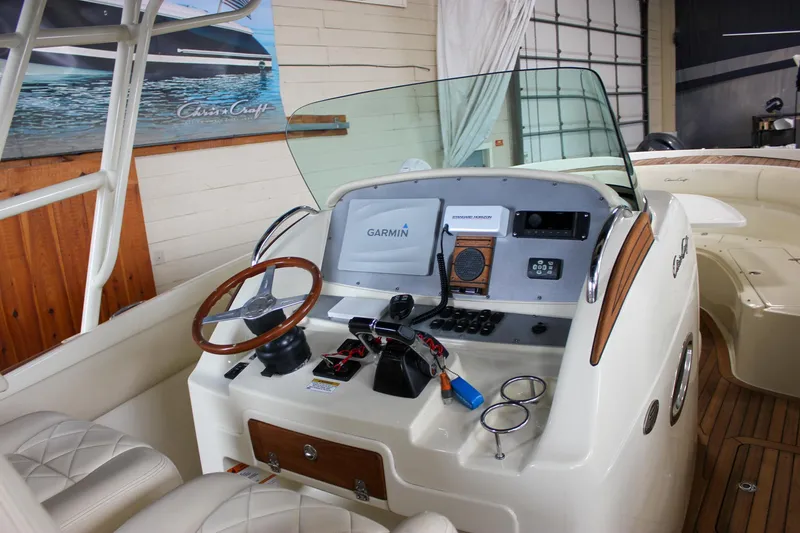 Slide: The Image of 2014 Chris-Craft Catalina 29 Sun Tender helm with Garmin navigation system and wooden steering wheel. - 16