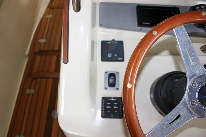 Slide: The Image of 2014 Chris-Craft Catalina 29 Sun Tender helm with wooden steering wheel and control panel. - 18