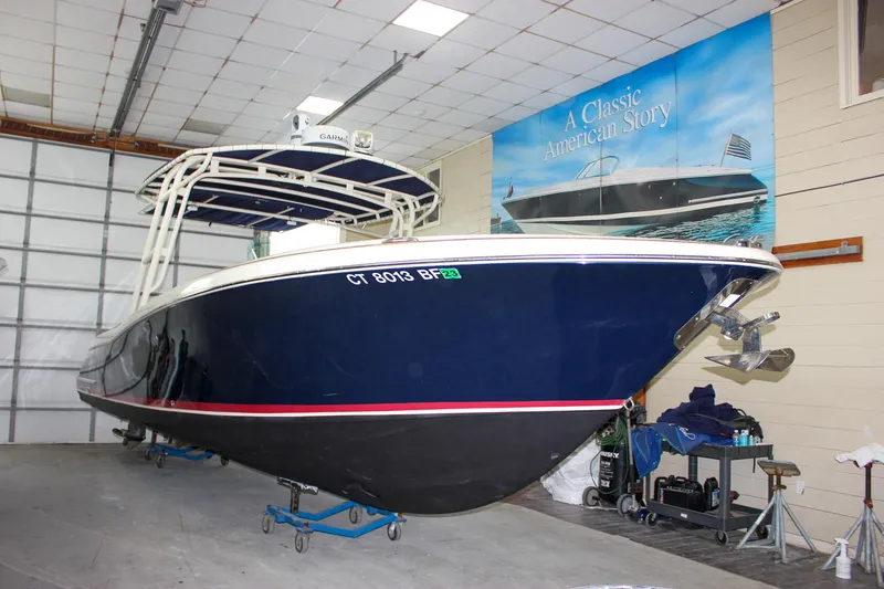Slide: The Image of 2014 Chris-Craft Catalina 29 Sun Tender in a garage, showcasing sleek design and classic style. - 3