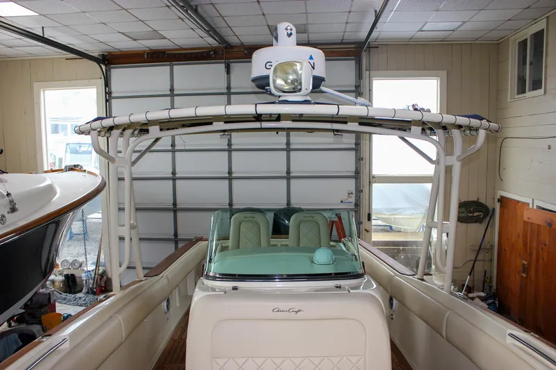 Slide: The Image of 2014 Chris-Craft Catalina 29 Sun Tender in a garage, showcasing its sleek design and radar equipment. - 34