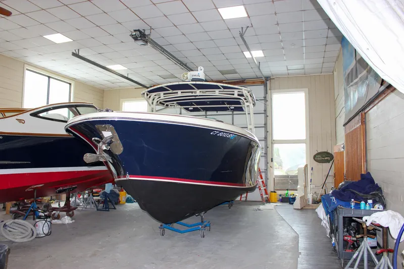 Slide: The Image of 2014 Chris-Craft Catalina 29 Sun Tender in indoor storage, blue hull, well-maintained condition. - 37