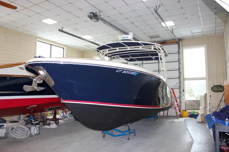 Slide: The Image of 2014 Chris-Craft Catalina 29 Sun Tender in a garage, blue hull, indoor storage. - 38