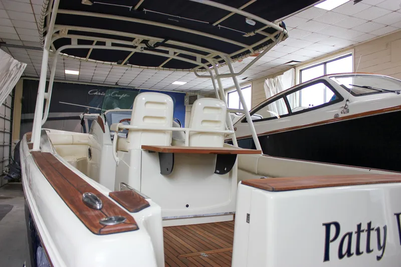 Slide: The Image of 2014 Chris-Craft Catalina 29 Sun Tender boat interior with seating and wood accents. - 6