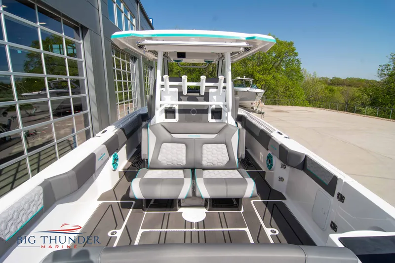 Slide: The Image of Interior view of a 2022 Fountain 32 NX boat, gray seating, modern design. - 12