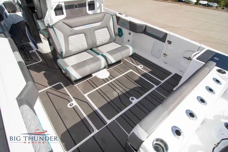 Slide: The Image of Interior of a 2022 Fountain 32 NX boat with gray seating. - 13
