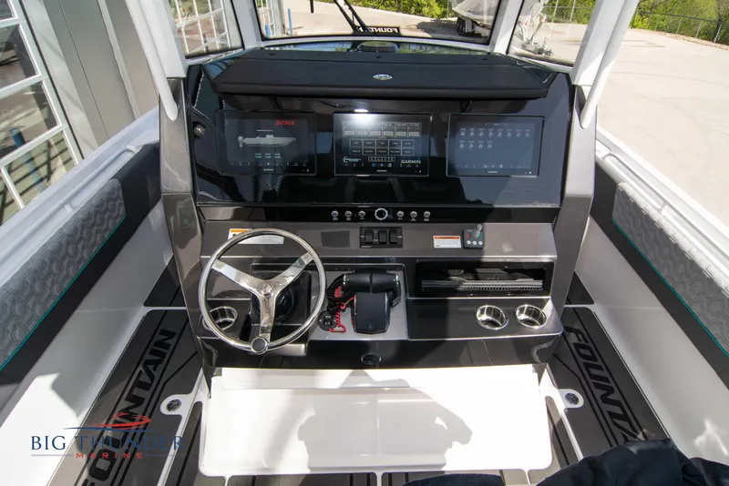 Slide: The Image of Interior view of 2022 Fountain 32 NX boat cockpit with modern controls. - 26
