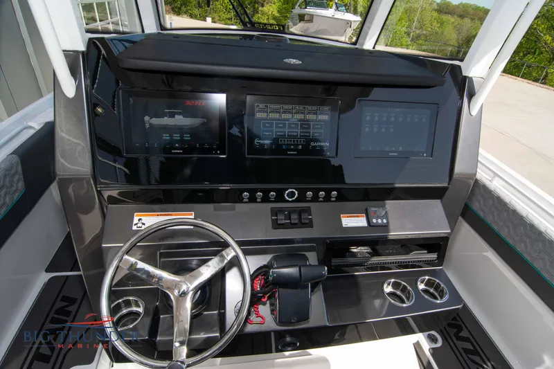 Slide: The Image of 2022 Fountain 32 NX cockpit with modern controls. - 30
