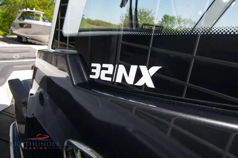 Slide: The Image of Fountain 32 NX boat, 2022 model, close-up of logo. - 43