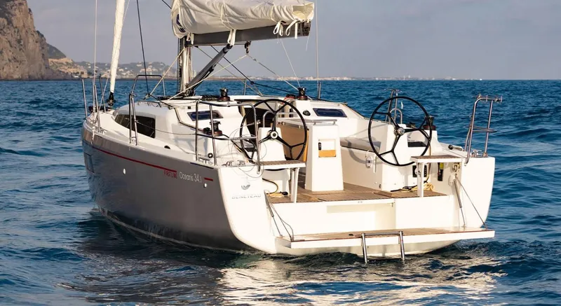 Slide: The Image of 2024 Beneteau Oceanis 34.1 sailboat on open water. - 2