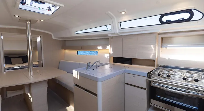 Slide: The Image of Modern interior of 2024 Beneteau Oceanis 34.1 sailboat with kitchen and dining area. - 4